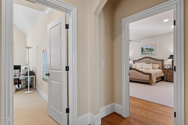 corridor with hardwood / wood-style flooring