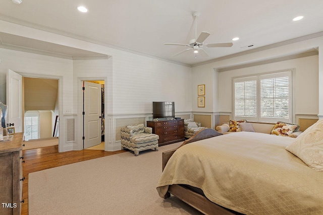 bedroom with ornamental molding and ceiling fan