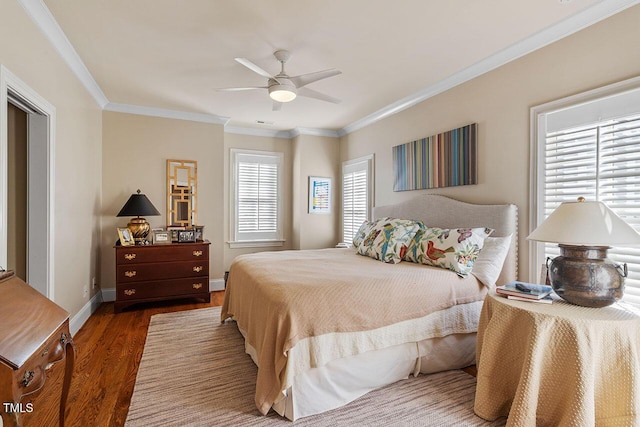 bedroom featuring hardwood / wood-style floors, crown molding, and ceiling fan