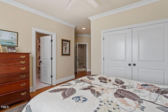 bedroom with crown molding, ceiling fan, a closet, and light wood-type flooring