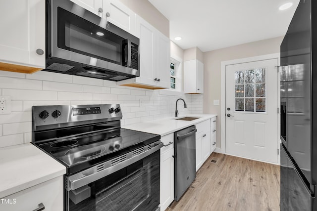 kitchen featuring white cabinetry, stainless steel appliances, and sink