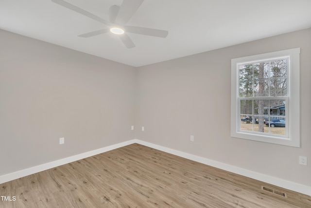 spare room with ceiling fan and light wood-type flooring