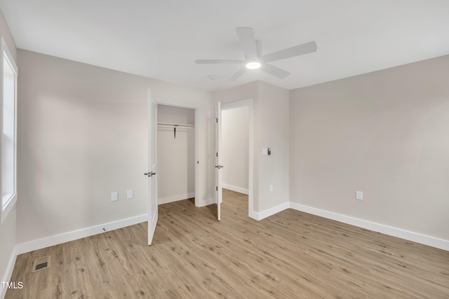 unfurnished bedroom with ceiling fan, a closet, and light wood-type flooring