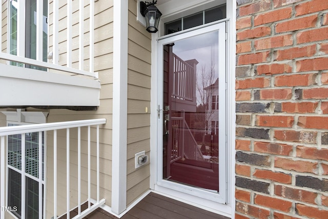 property entrance with brick siding