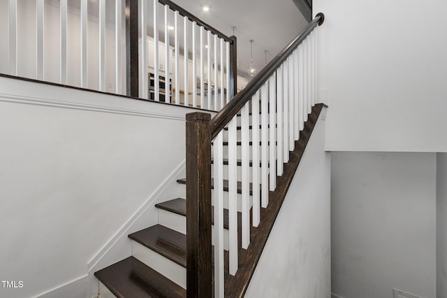 stairs featuring hardwood / wood-style floors