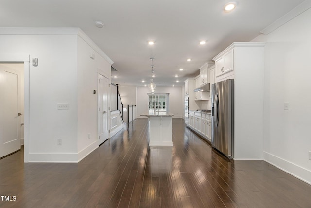 kitchen with a kitchen island, dark hardwood / wood-style floors, white cabinets, hanging light fixtures, and stainless steel appliances