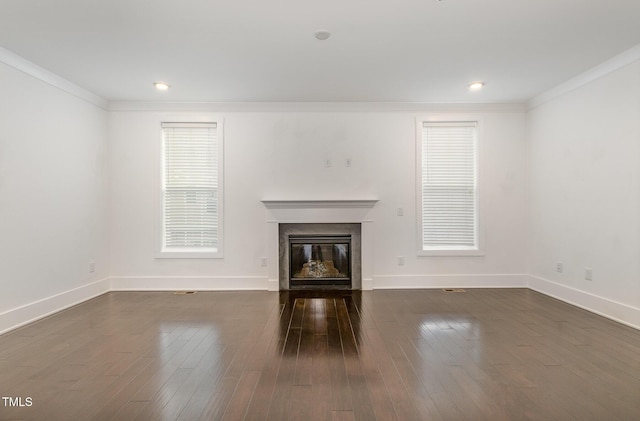 unfurnished living room with crown molding and dark hardwood / wood-style flooring