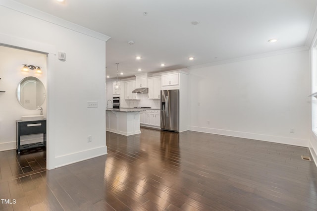 living room with crown molding, dark hardwood / wood-style floors, and sink