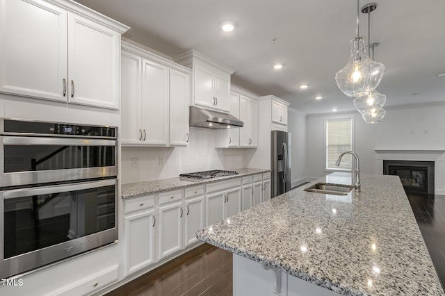 kitchen with white cabinetry, stainless steel appliances, and sink