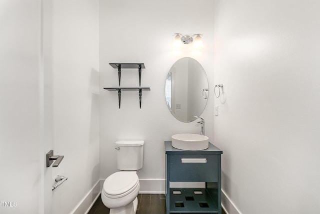 bathroom with vanity, hardwood / wood-style flooring, and toilet