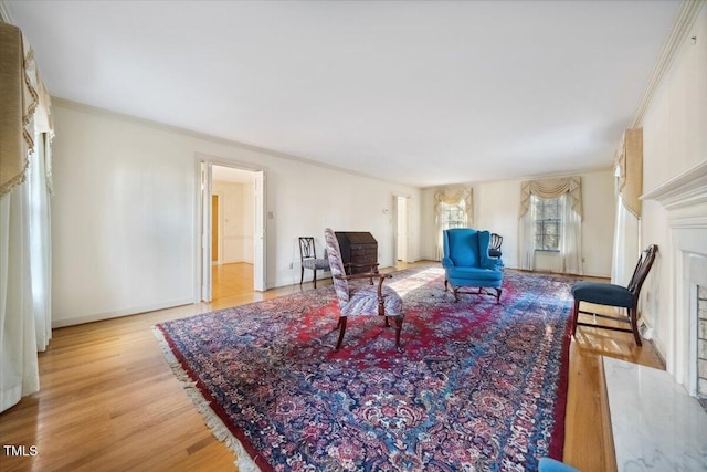 living room with crown molding and light hardwood / wood-style floors