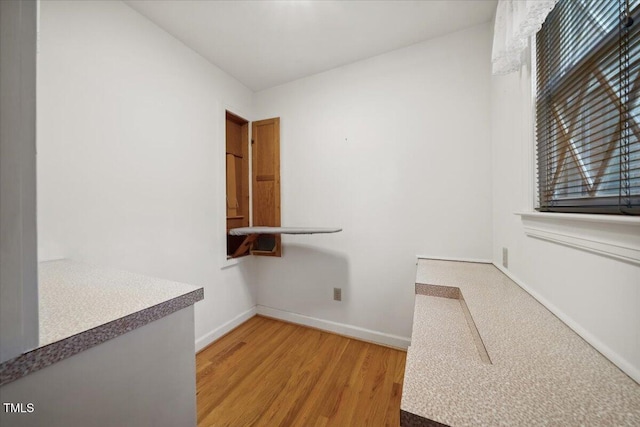 clothes washing area featuring hardwood / wood-style flooring