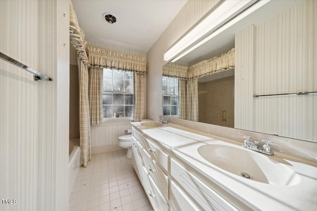 full bathroom with tile patterned floors, vanity, toilet, and shower / tub combo