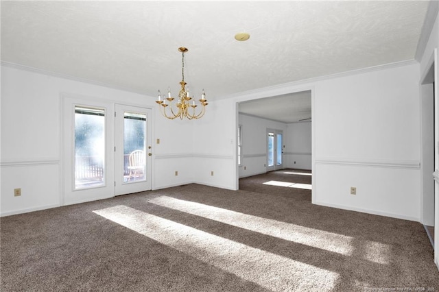 carpeted spare room with crown molding and a chandelier