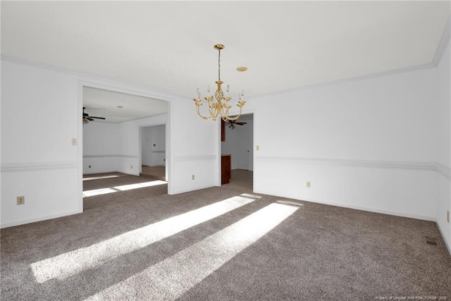 carpeted spare room featuring an inviting chandelier and ornamental molding