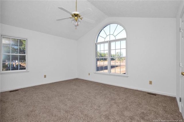 empty room with lofted ceiling, carpet flooring, and ceiling fan