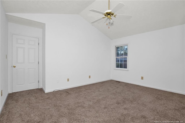 carpeted empty room with vaulted ceiling and ceiling fan