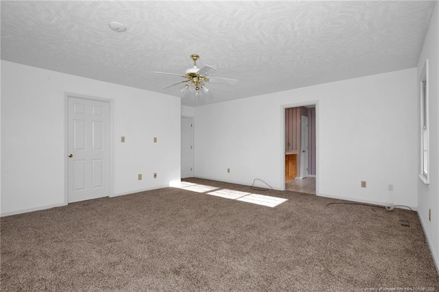 unfurnished room with ceiling fan, light carpet, and a textured ceiling