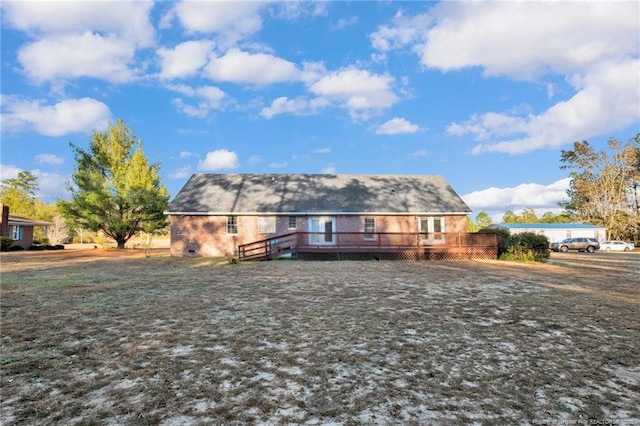 rear view of property featuring a deck