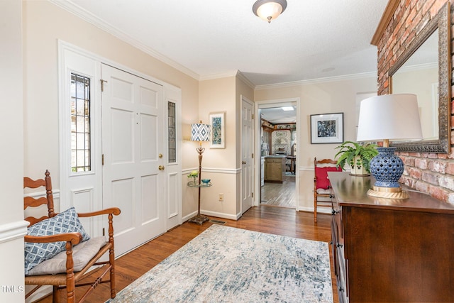 foyer with crown molding and dark wood-type flooring