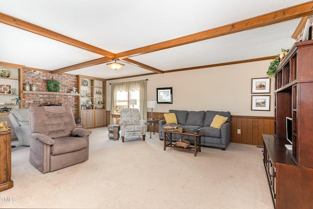 living room featuring beam ceiling, ornamental molding, light carpet, and a fireplace