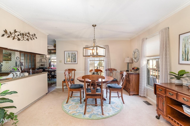 dining space featuring light carpet and ornamental molding