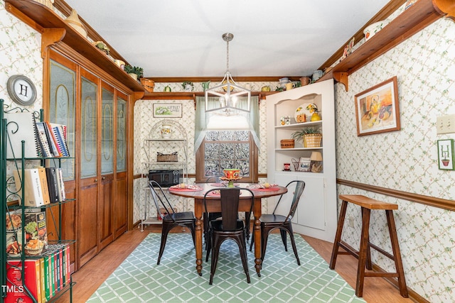 dining space featuring wood-type flooring and a chandelier