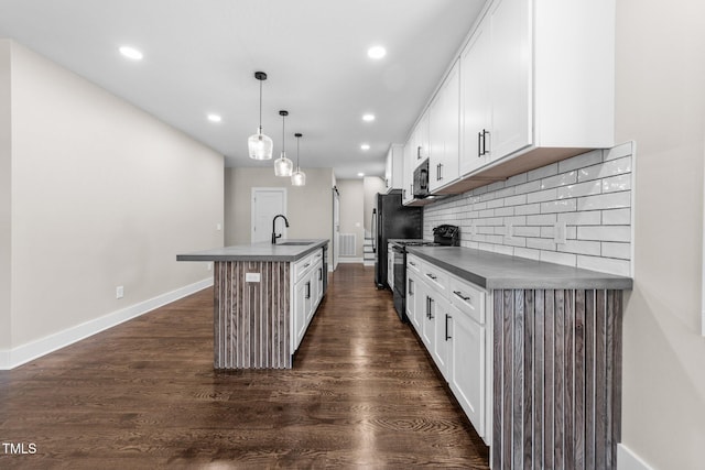 kitchen with pendant lighting, white cabinetry, sink, and black appliances