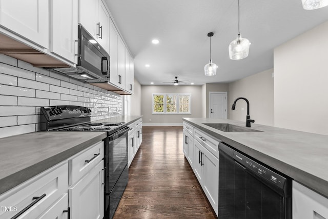 kitchen with sink, decorative light fixtures, black appliances, and white cabinets