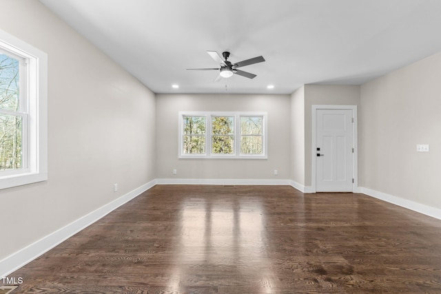 spare room featuring dark hardwood / wood-style flooring and ceiling fan