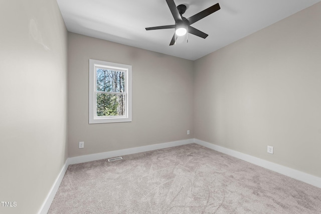 carpeted spare room with ceiling fan