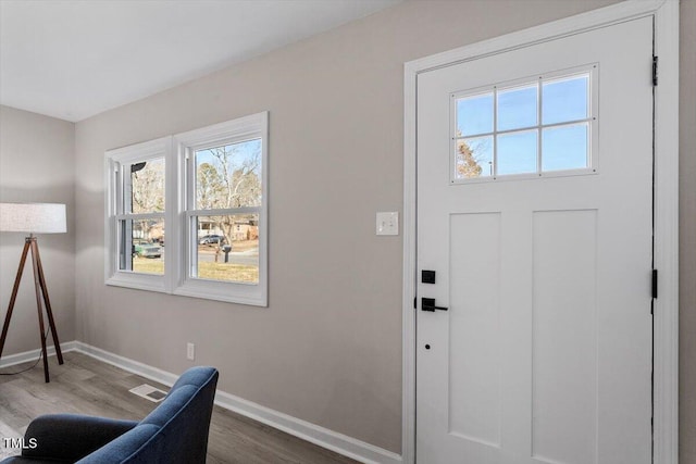 entrance foyer featuring visible vents, baseboards, and wood finished floors