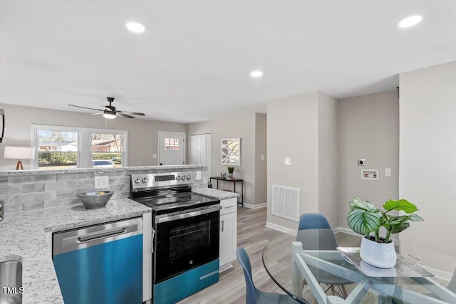 kitchen with recessed lighting, visible vents, appliances with stainless steel finishes, light wood-type flooring, and tasteful backsplash