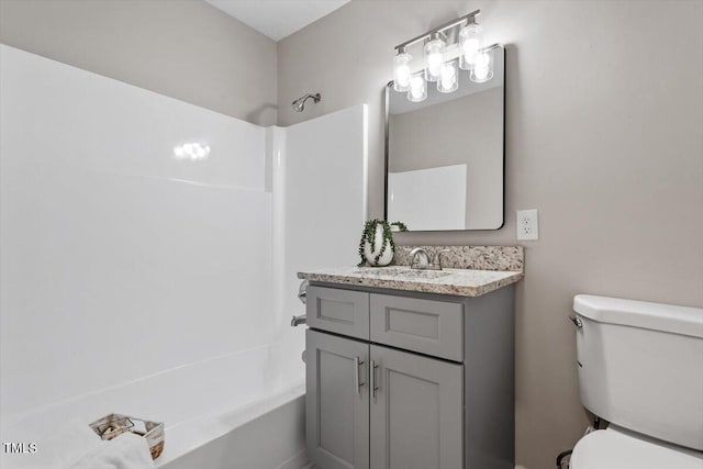 full bathroom with vanity, shower / tub combination, and toilet