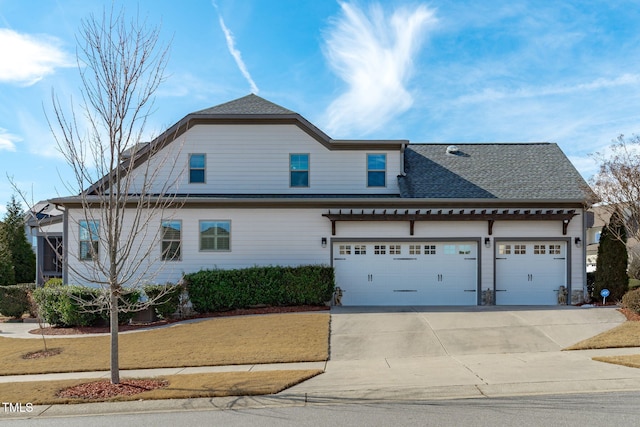 view of front of property with a garage and a front lawn