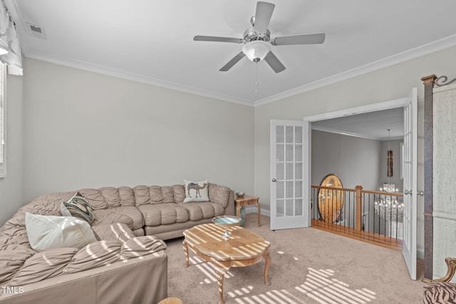 carpeted living room with ornamental molding, french doors, and ceiling fan