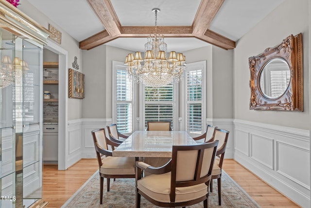 dining area featuring beam ceiling, a healthy amount of sunlight, and light wood-type flooring