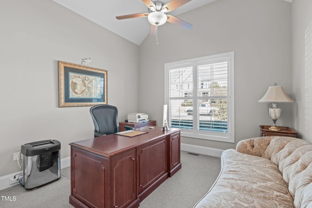 carpeted office with lofted ceiling and ceiling fan