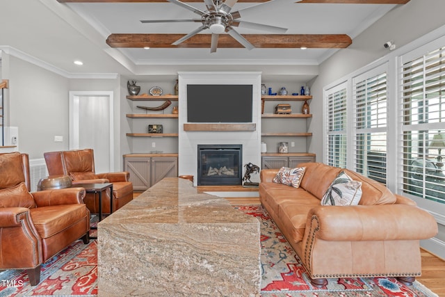 living room featuring crown molding, light wood-type flooring, ceiling fan, and beam ceiling