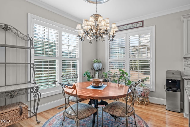 dining space featuring a healthy amount of sunlight, ornamental molding, and light hardwood / wood-style floors