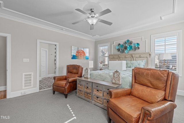 bedroom featuring multiple windows, ornamental molding, light carpet, and ceiling fan