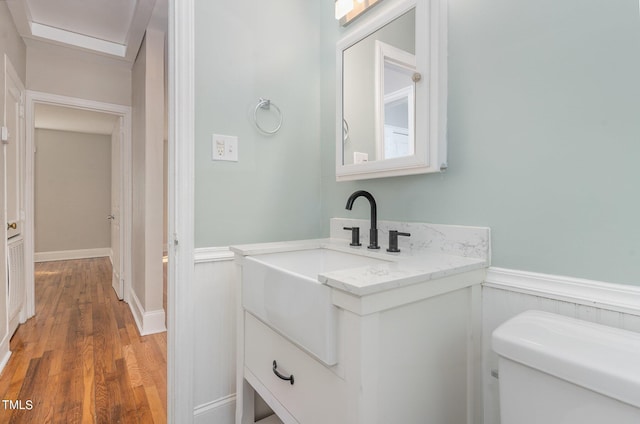 bathroom with vanity, hardwood / wood-style floors, and toilet