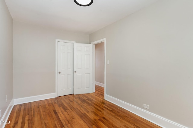 unfurnished bedroom featuring hardwood / wood-style floors and a closet