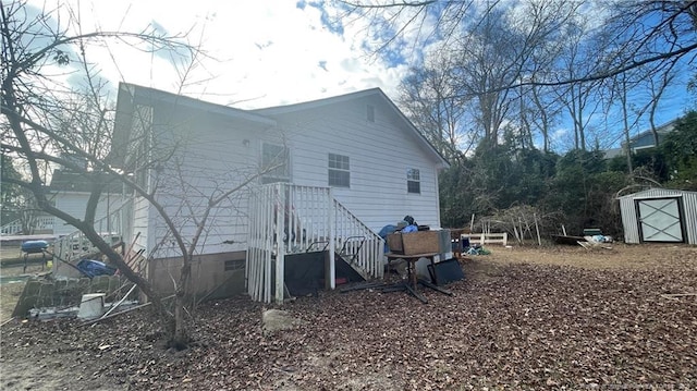 back of property featuring a storage shed