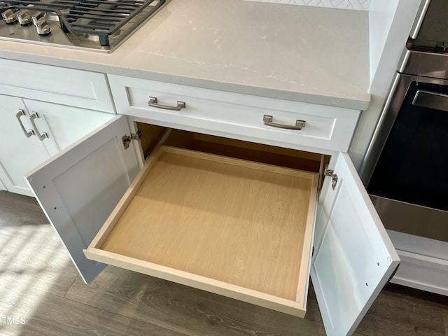 interior details with white cabinetry, wall oven, and stainless steel gas cooktop