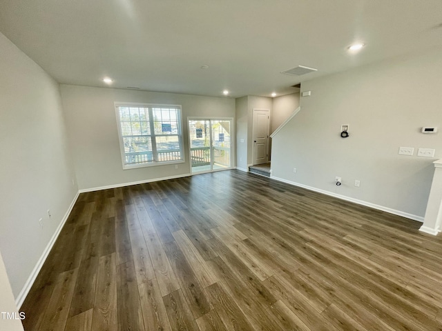 spare room featuring dark wood-type flooring