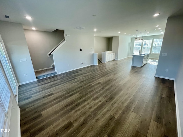 unfurnished living room featuring dark hardwood / wood-style floors