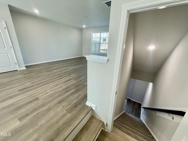 stairway with hardwood / wood-style floors