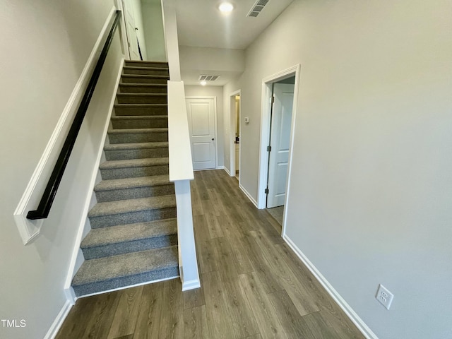 stairway with wood-type flooring