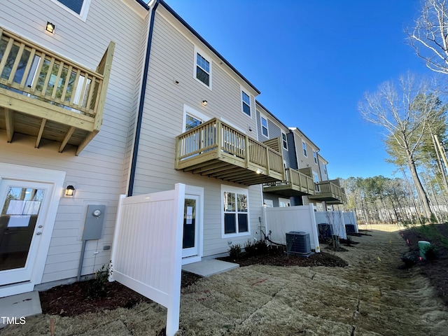 rear view of house featuring central AC